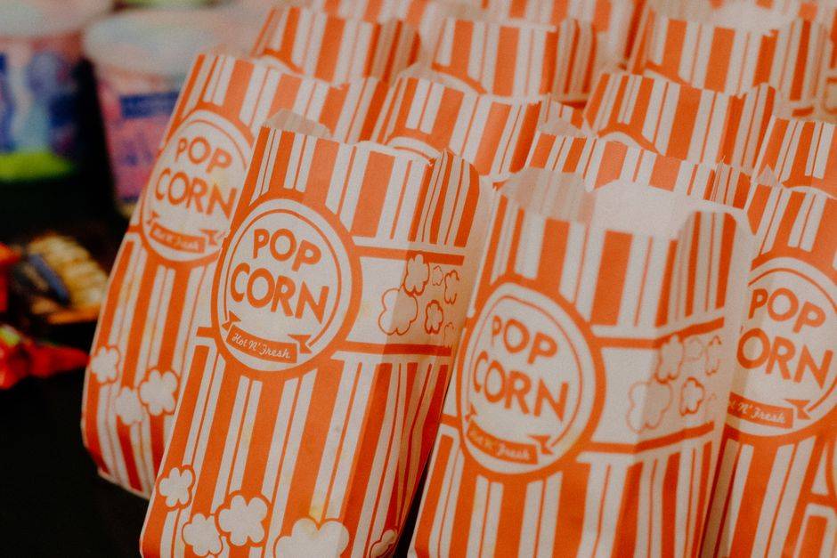 Colorful striped popcorn bags neatly arranged, ready for serving at a concession stand.